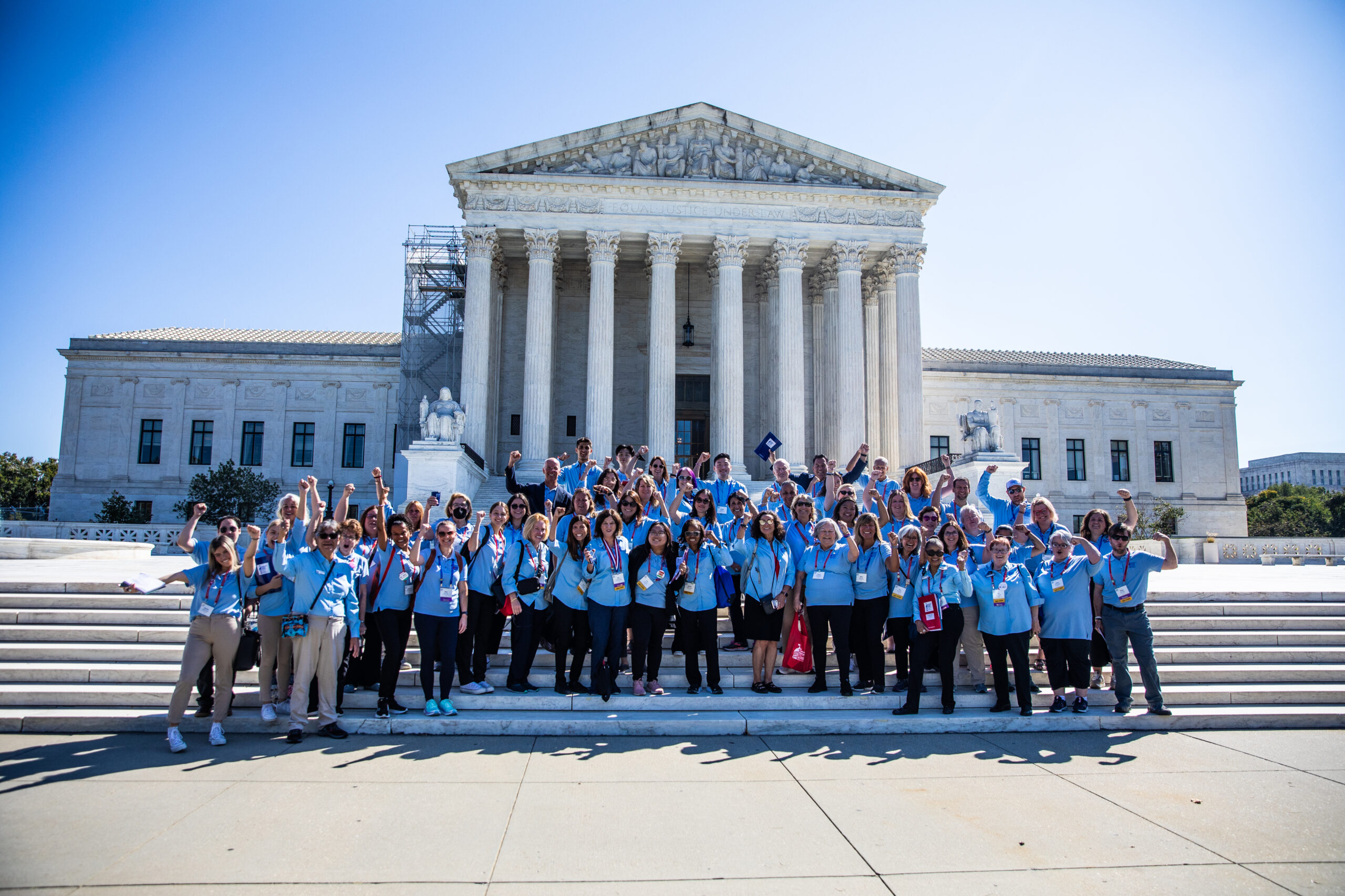 volunteers in blue shirts at leadership summit and lobby day