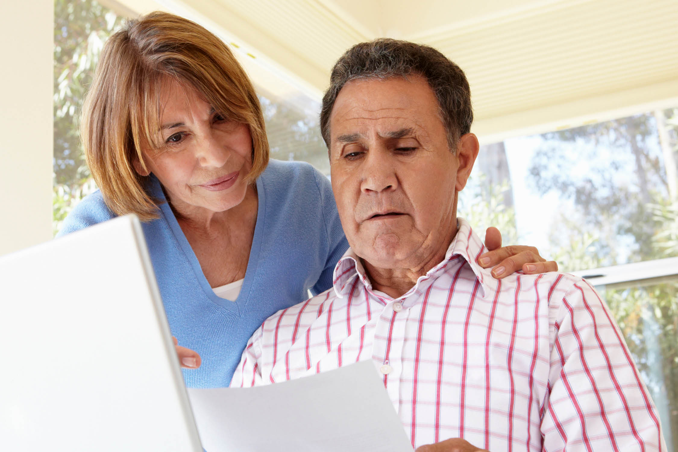 Senior Hispanic Couple Working In Home Office