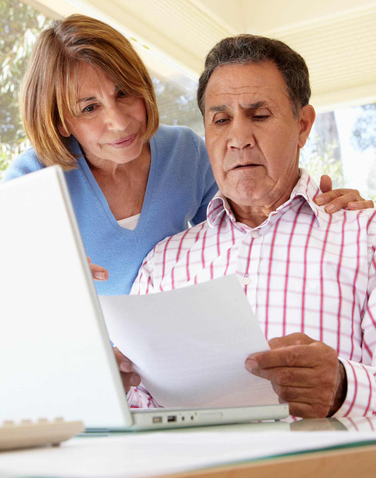 Senior Hispanic Couple Working In Home Office