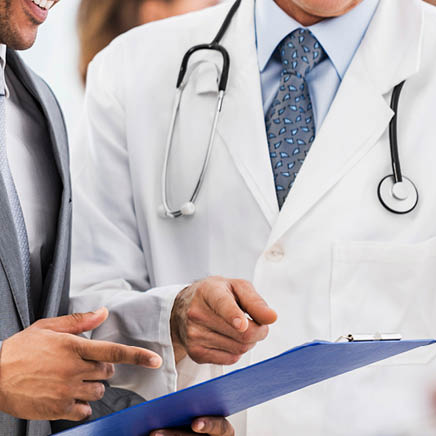 Mature doctor and African American businessman looking at documents  There are people around them    url http:  www istockphoto com search lightbox 9786662  img http:  dl dropbox com u 40117171 medicine jpg  img   url    url http:  www istockphoto com search lightbox 9786622  img http:  dl dropbox com u 40117171 business jpg  img   url