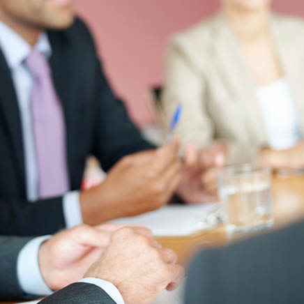 Portrait of a mature business man having a meeting with his colleague in boardroom
