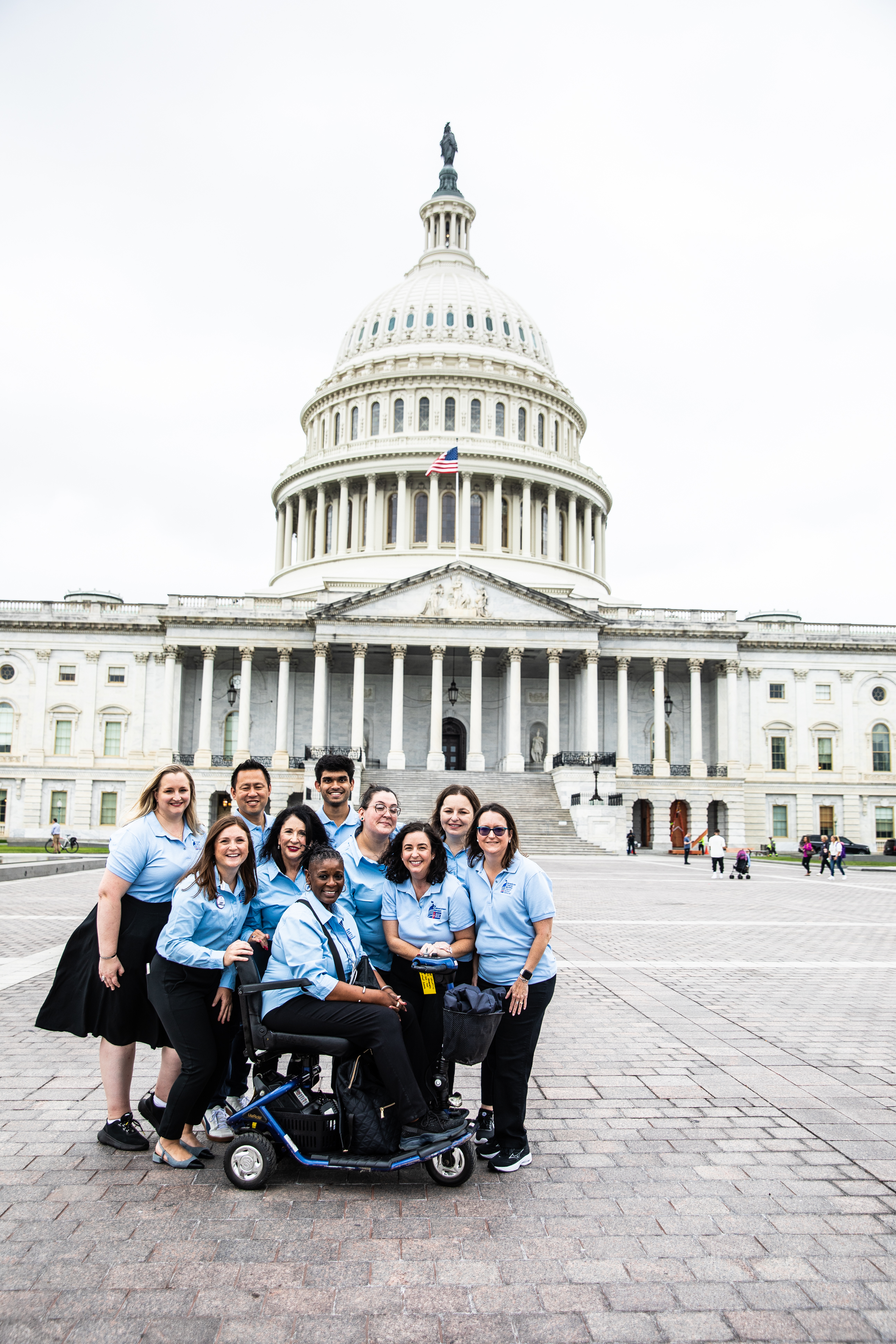 blue shirt volunteers in front of the US capitol