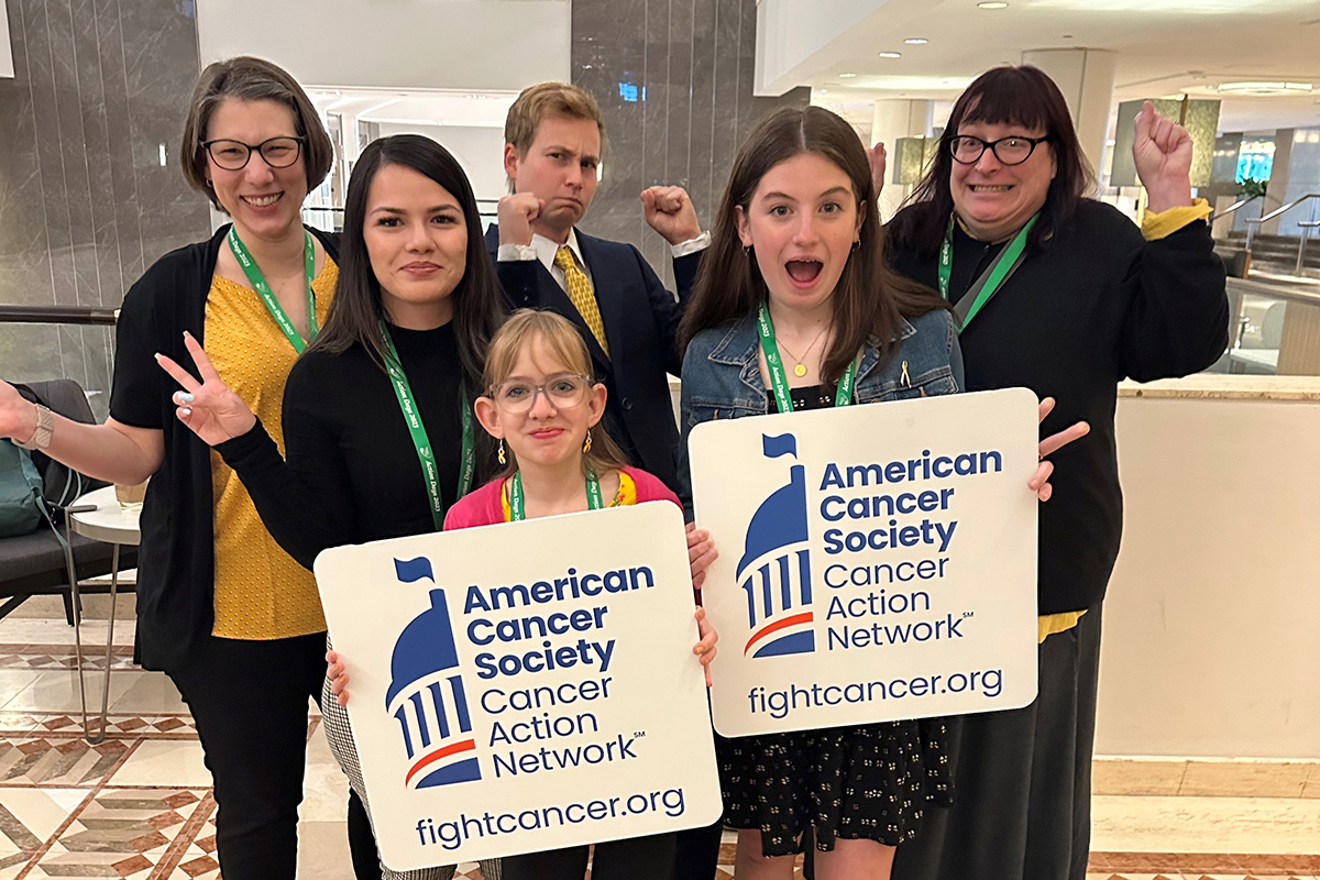 Cancer Action Day survivors posing with arms raised in excitement