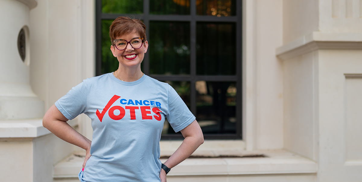 A Cancer Votes volunteer standing and smiling