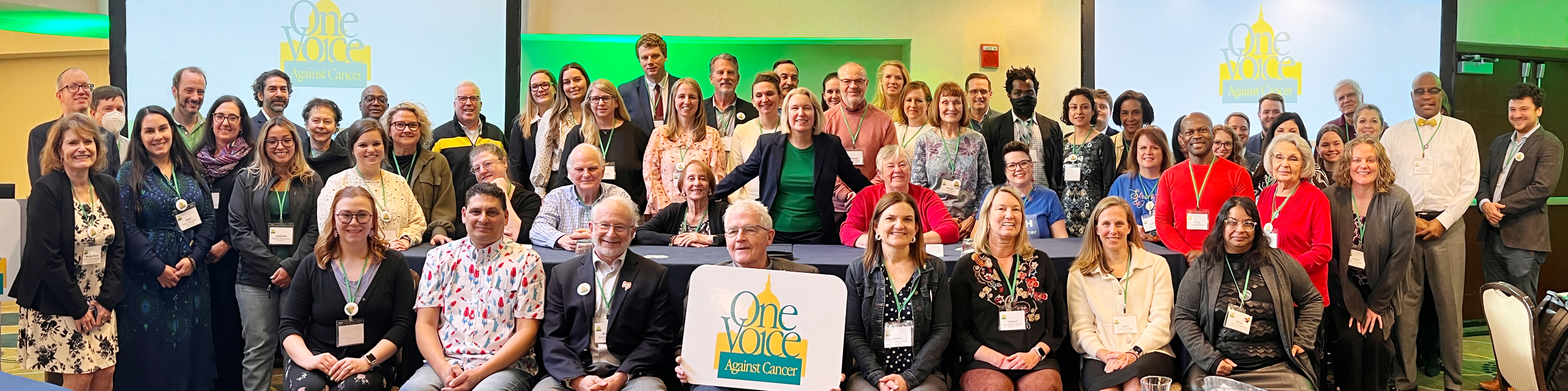 a large group of volunteers at OVAC lobby day with the logo in the center