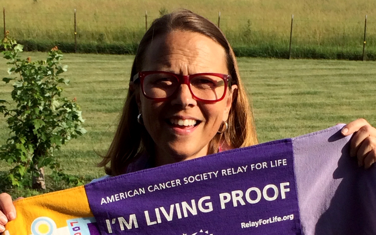 Julie Turner holding a relay for life banner