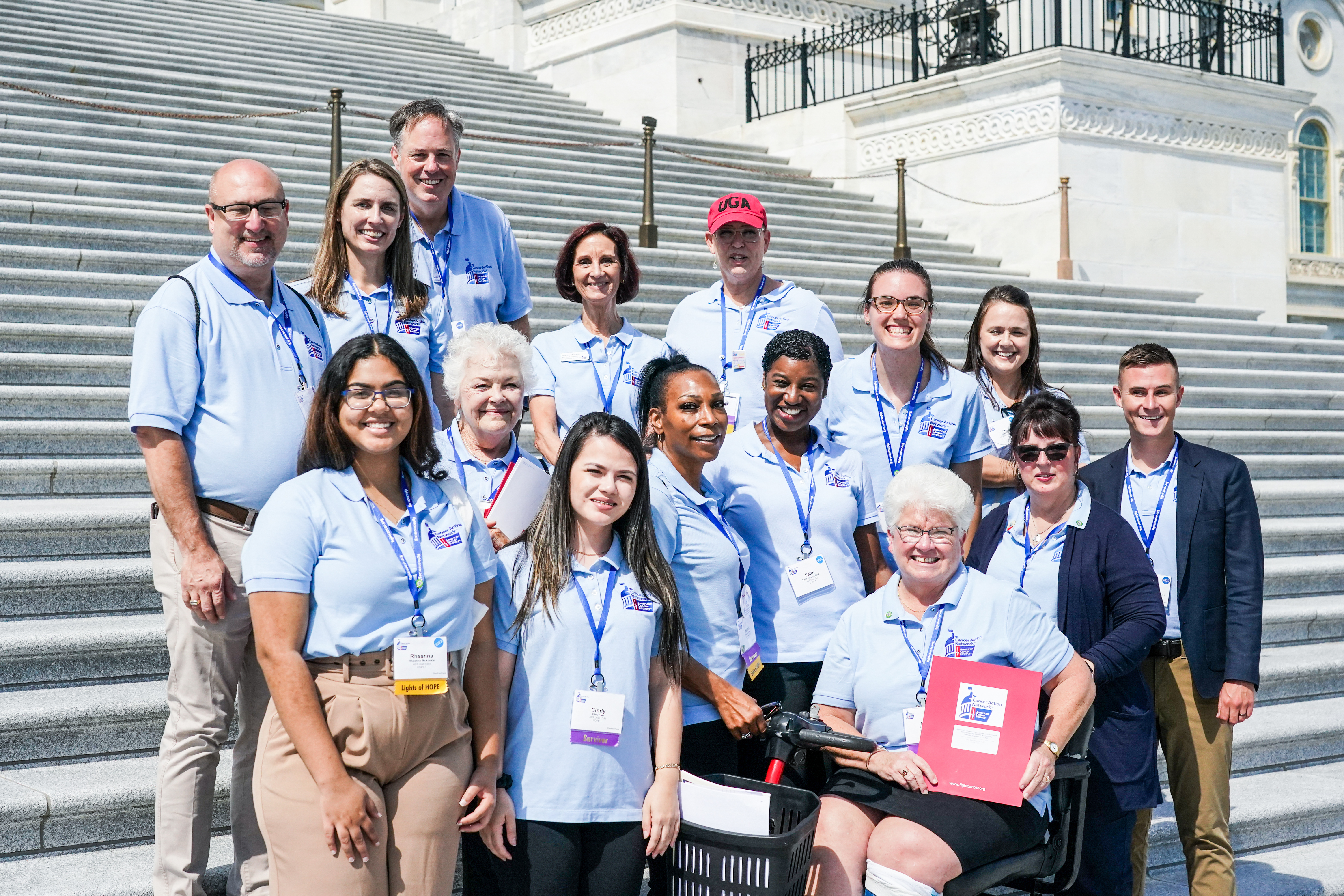 a diverse group of volunteers standing in front of the steps of the captiol
