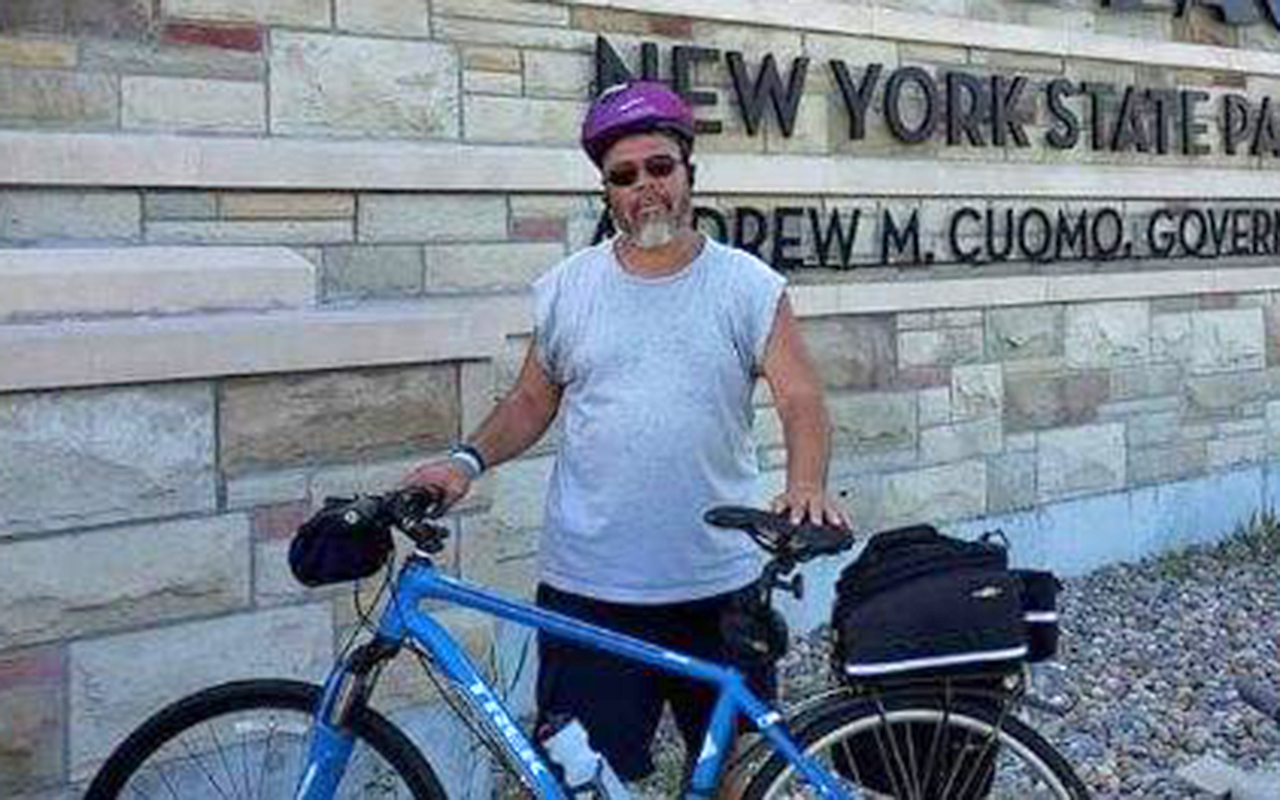 Miguel Melendez standing with a bike.