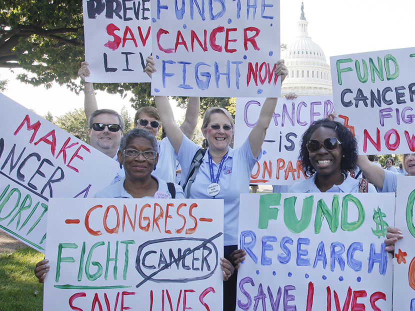 Volunteers holding signs at a lobby day event