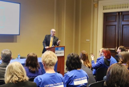 Crowd shot of Dr. Wender speaking at event.