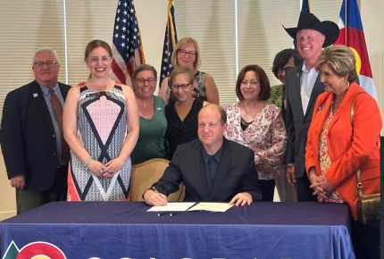 Volunteers attend bill signing ceremony