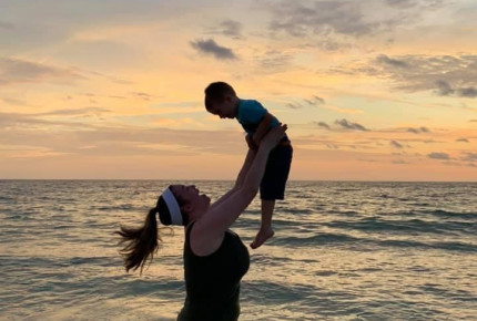 Leah McCleary holding son in sunset