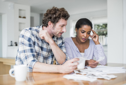 tensed couple reading bills