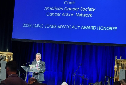 John at podium at event