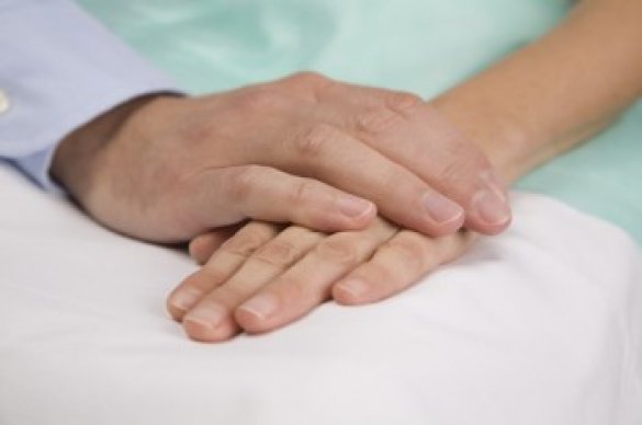 Two people touching hands together