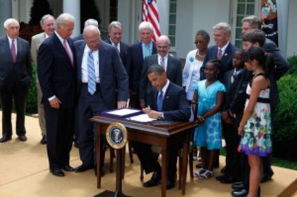 President Obama signing paper