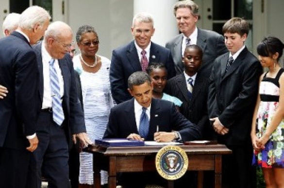 Barack Obama signing paper