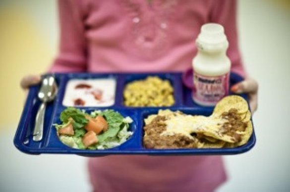 Girl holding school lunch tray