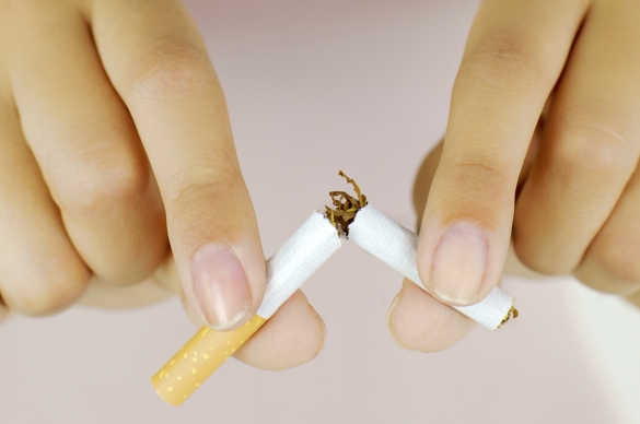 Photo of two hands breaking a cigarette