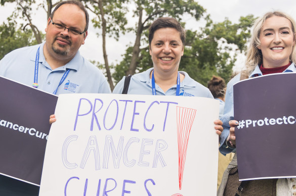 Volunteers holding signs at a rally