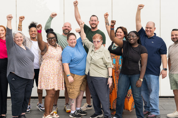 Volunteers with hands raised