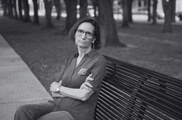 woman with serious expression sitting on bench_black and white image