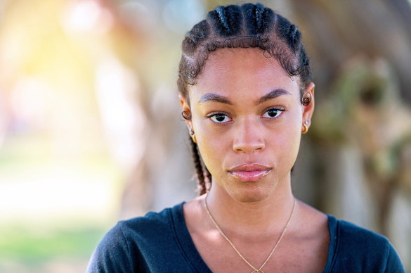 a young black woman looking sternly at the camera