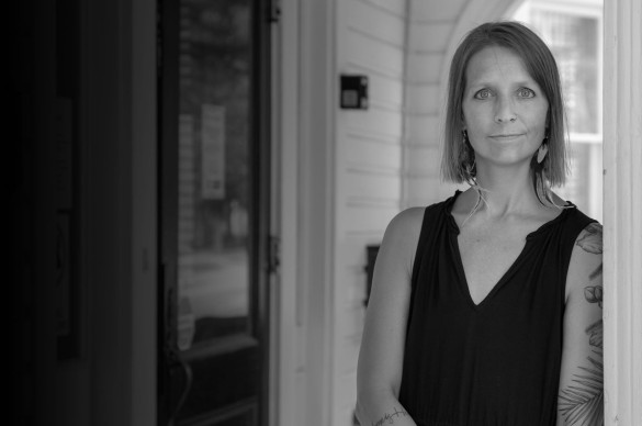 Woman with serious expression looking at the camera, black and white image