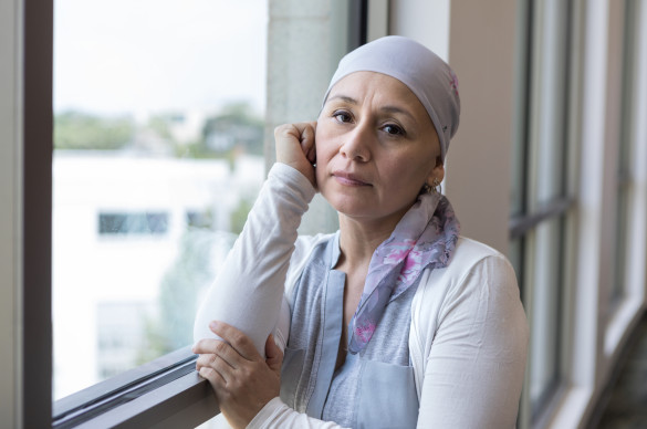 mid_adult_woman_fighting_cancer_faces_camera