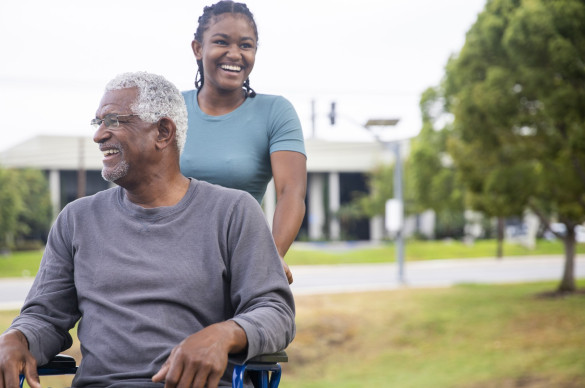 senior black man in wheelchair with daughter