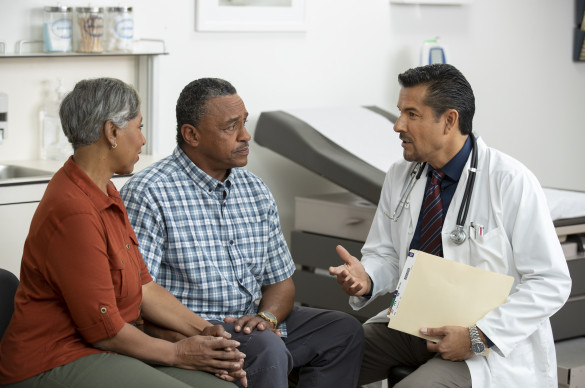 Doctor discussing with elderly patient and his partner