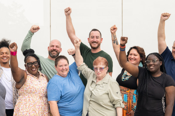 Volunteers with arms raised