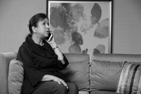 woman on phone with serious expression, left aligned 