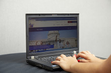 Volunteer using a computer to take action on the ACS CAN website