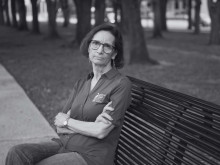 woman with serious expression sitting on bench_black and white image