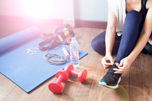 Woman lacing up her shoes