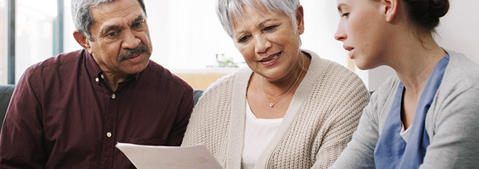 A man and two women reviewing medical information