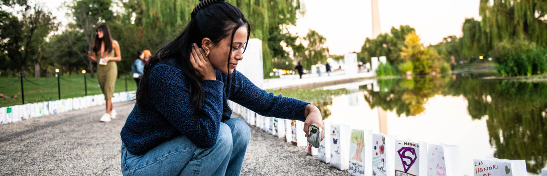 Volunteer taking photos of lights of hope bags