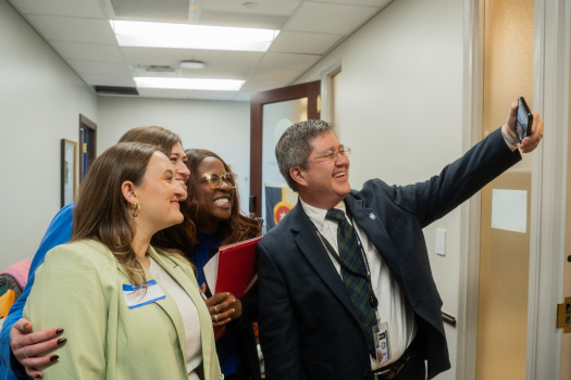 Three volunteers posing for a selfie with Oklahoma lawmaker