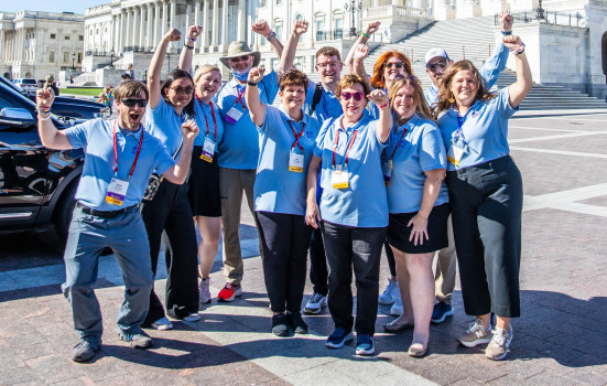 group of volunteers with fists in the air