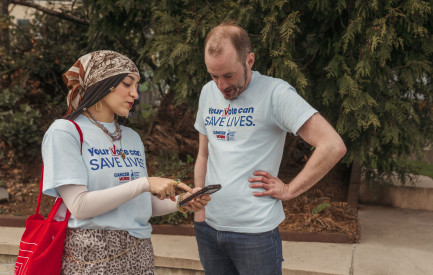 Cancer Votes volunteers looking at phone