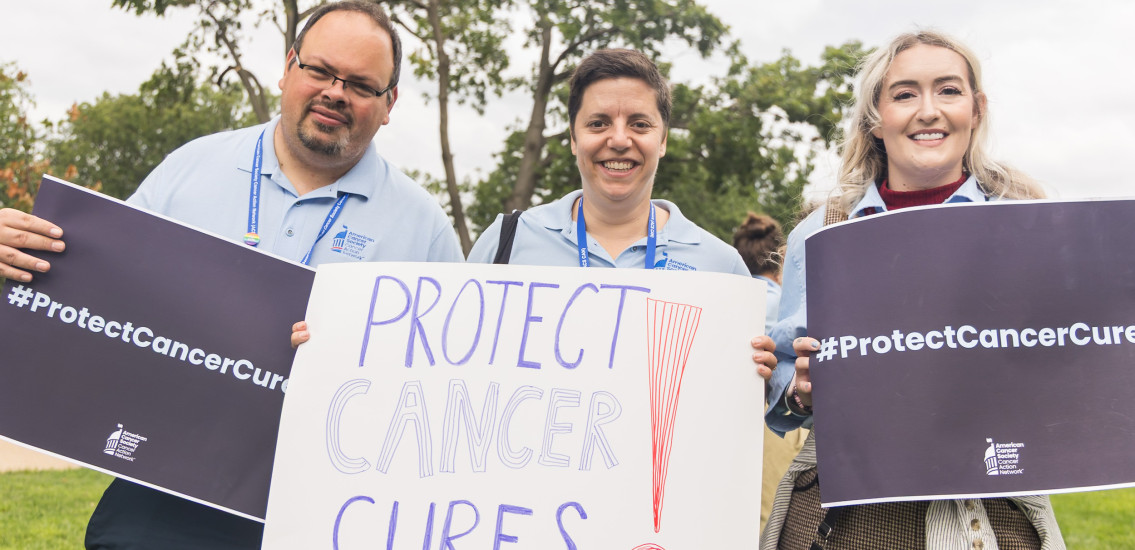 Volunteers holding signs at a rally