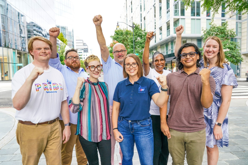 A group of volunteers with fists raised