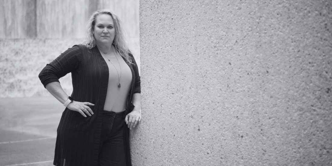 woman with serious expression posing and staring at camera, black and white image