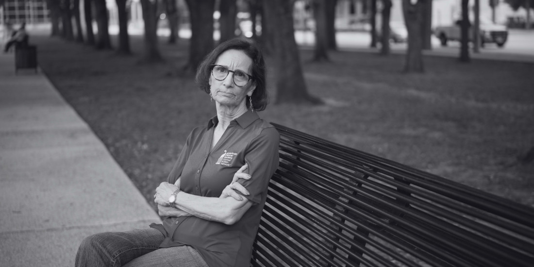 woman with serious expression sitting on bench_black and white image