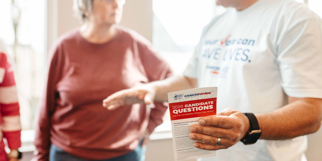 Cancer Votes volunteers talking in the background with candidate questionnaire in focus