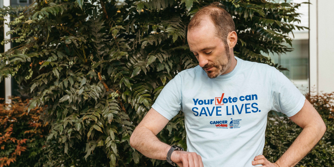 cancer votes volunteer looking down at his watch