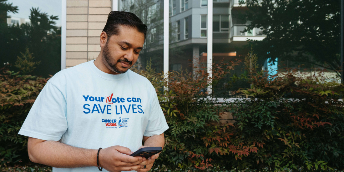 Cancer Votes volunteer looking down at his phone