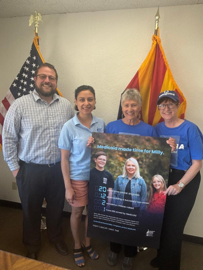 ACS CAN volunteers hold a poster about the importance of Medicaid