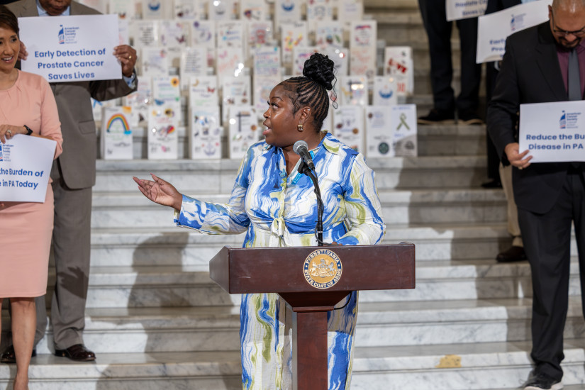 Audra speaking at a podium 